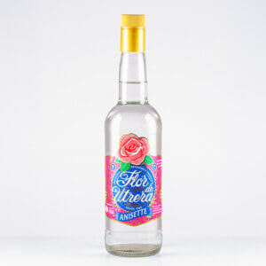 Botella de anís Flor de Utrera Anisette con etiqueta rosa y fondo blanco